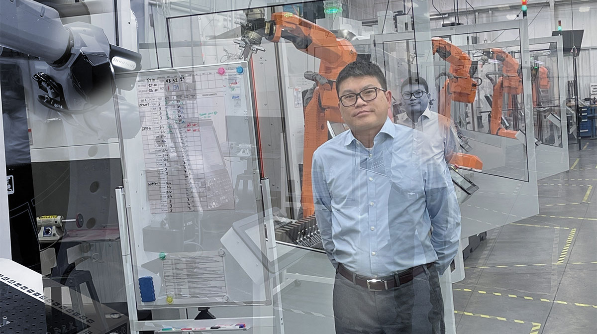 Man in front of industry robots for manufacturing